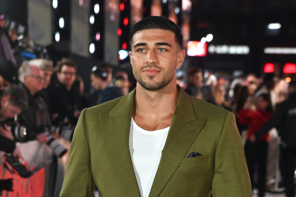 Tommy Fury wearing a white top and green-brown suit jacket at a 'MobLand' Premiere
