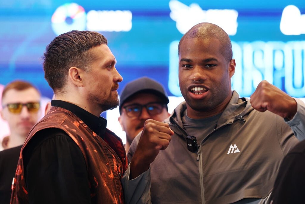Oleksandr Usyk stares at Daniel Dubois who poses with his fists up at the face-off