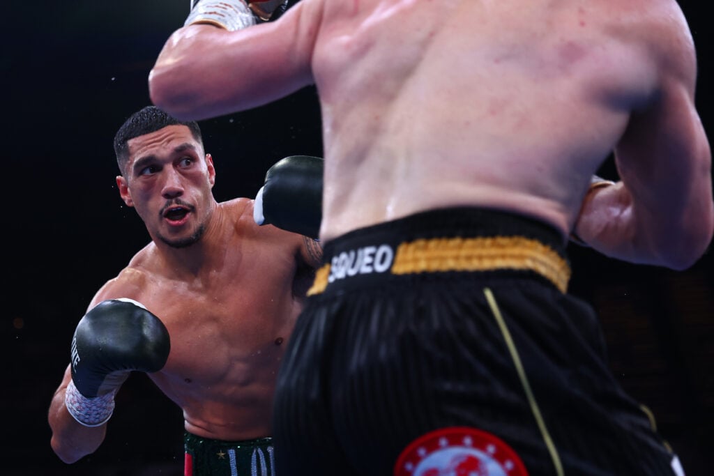 Claudio Squeo's back is to the camera as he faces Jai Opetaia