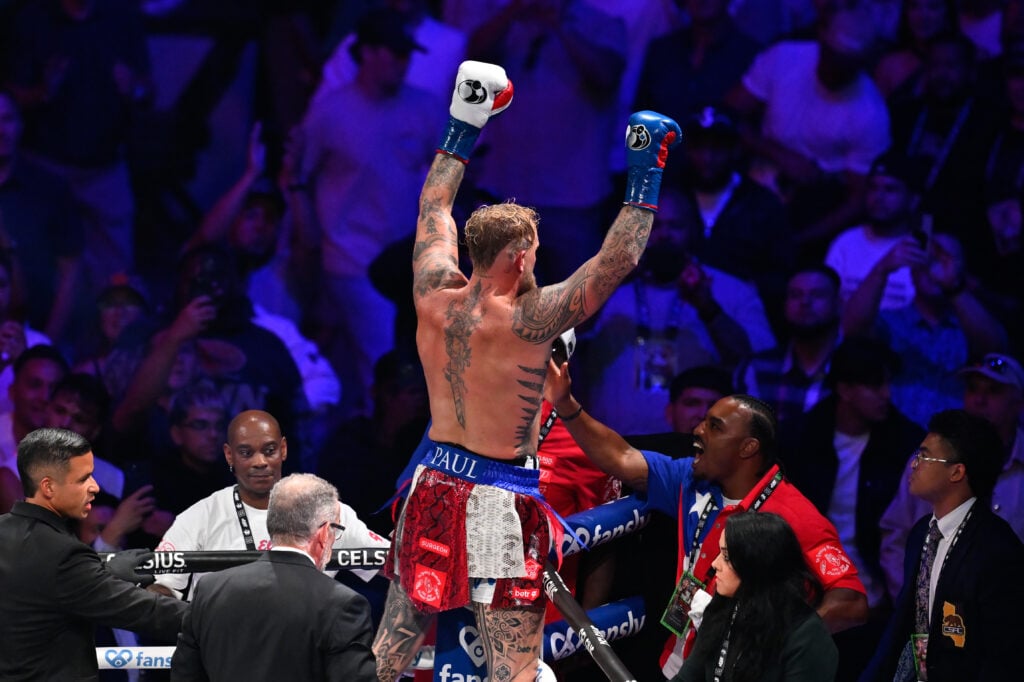 Jake Paul stands in his corner with his hands in the air after defeating Julio Cesar Chavez Jr