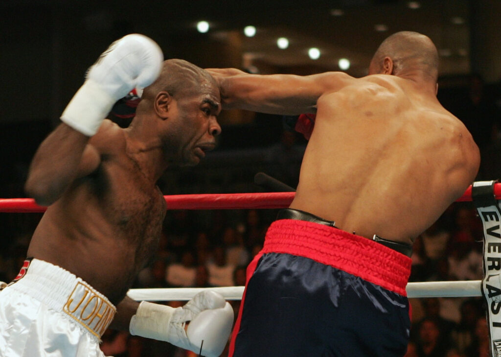 Glen Johnson throws a punch at Roy Jones Jr.