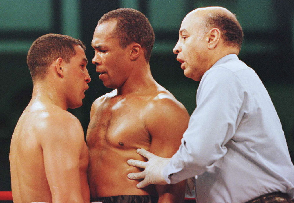 Referee Joe Cortez steps in to break up an exchang