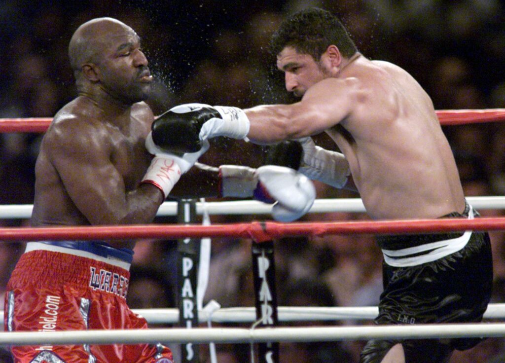 US boxer John Ruiz of Chelsea, MA (R), lands a blow on Evander Holyfield