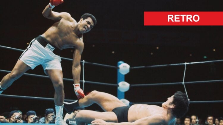 Muhammad Ali winces in pain after being kicked by Antonio Inoki in their "War of the Worlds" fight in 1976