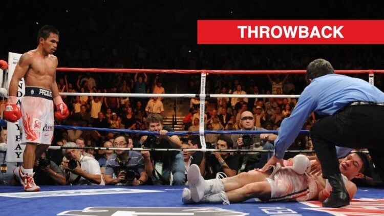 Manny Pacquiao stands in his corner watching on as David Diaz, who is lying on the canvas, is tended to by the referee