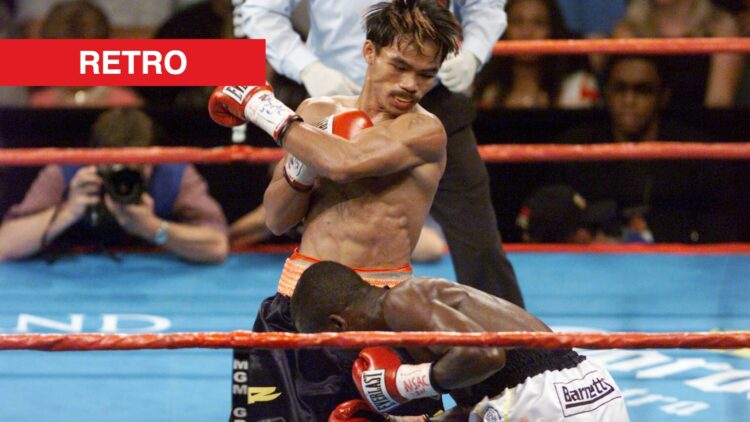 Manny Pacquiao swings a left hook as Lehlohonolo Ledwaba ducks under his arm during the IBF Super Bantamweight Championship bout
