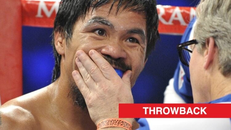 Manny Pacquiao has his gumshield put in by Freddie Roach in his corner