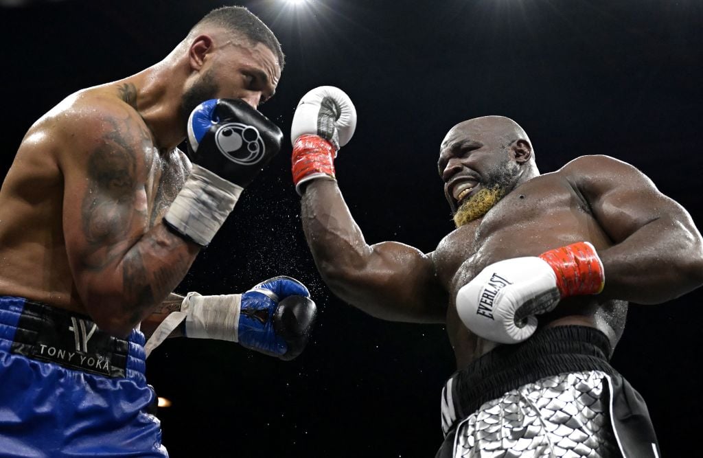 Carlos Takam throws a right uppercut at Tony Yoka