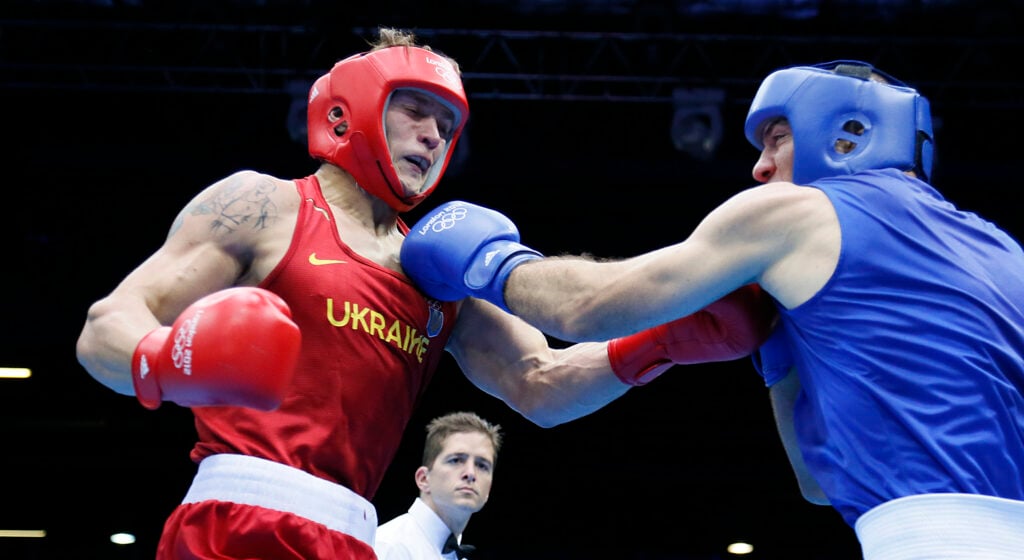 Tervel Pulev lands a left hand as Oleksandr Usyk lands a right hand on him
