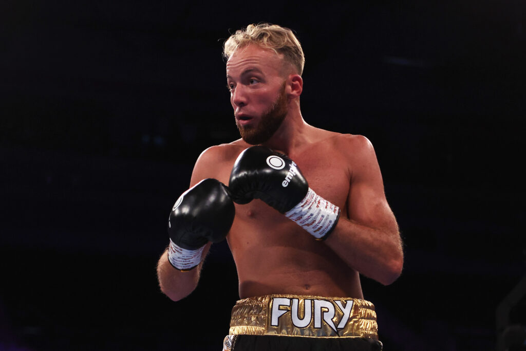 Walter Fury holds his hands up during his fight with Dale Arrowsmith