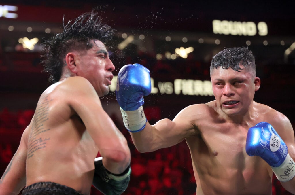 Isaac Cruz lands a right hook on the head of Angel Fierro