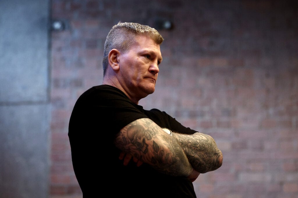 Ricky Hatton with his arms crossed, looking sternly in a gym.