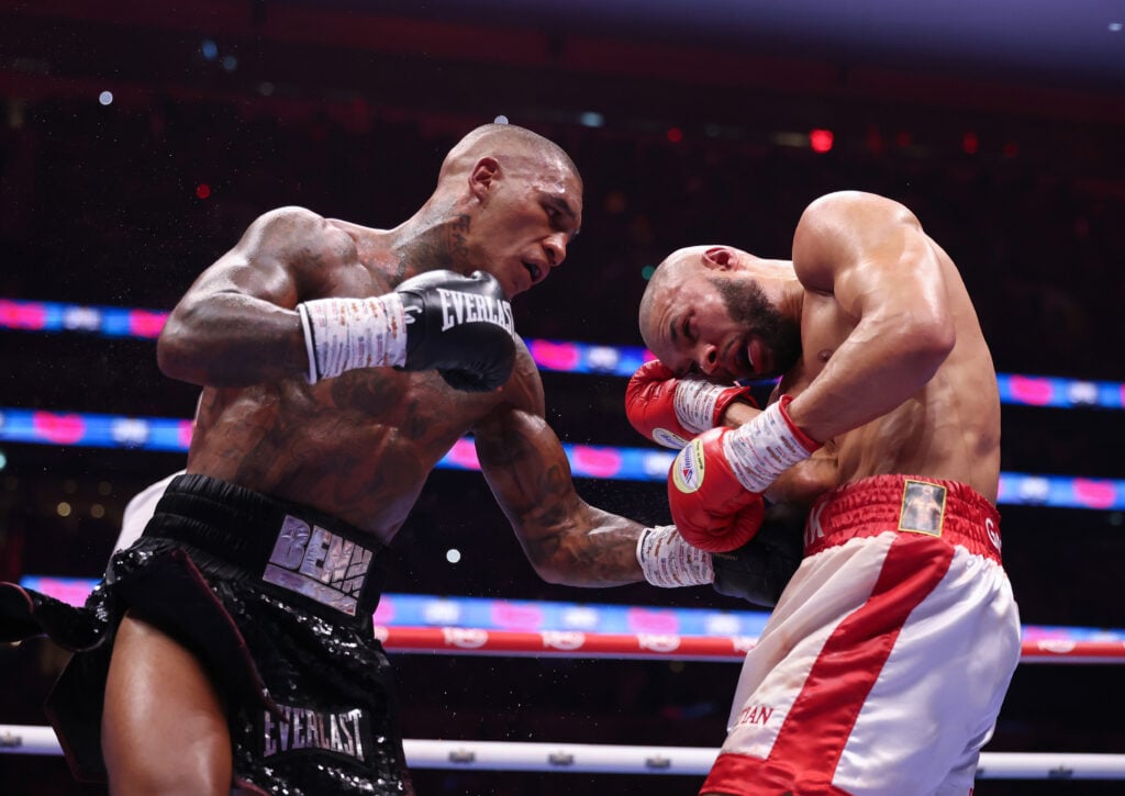Conor Benn throws a left uppercut at Chris Eubank Jr, who blocks it