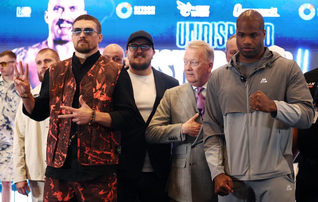Oleksandr Usyk and Daniel Dubois pose on stage at the press conference announcing their upcoming fight.