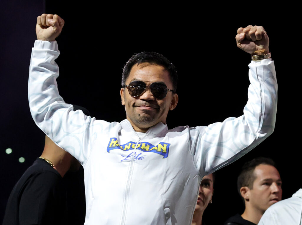 Manny Pacquiao poses with his hands in the airm