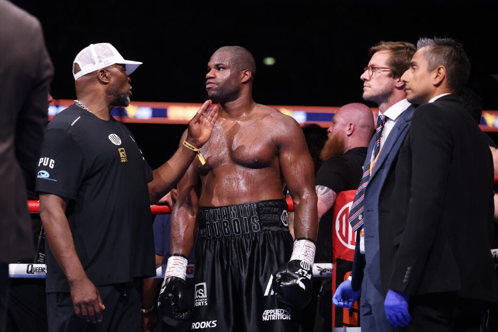 Daniel Dubois being comforted by coach after loss