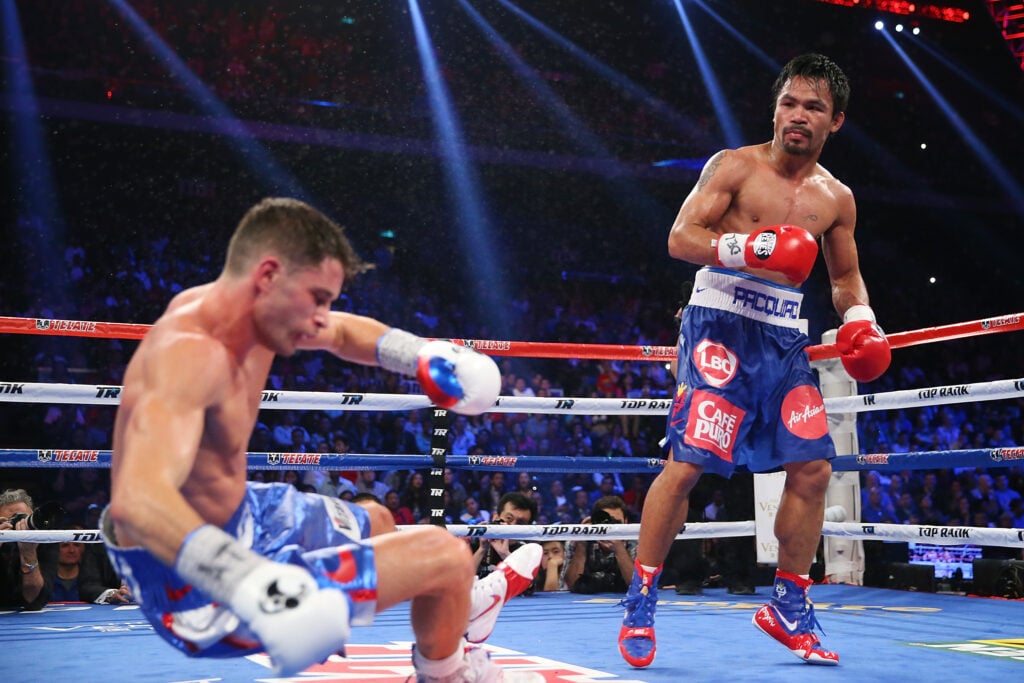 Chris Algieri topples backwards to the canvas after being struck by Manny Pacquiao