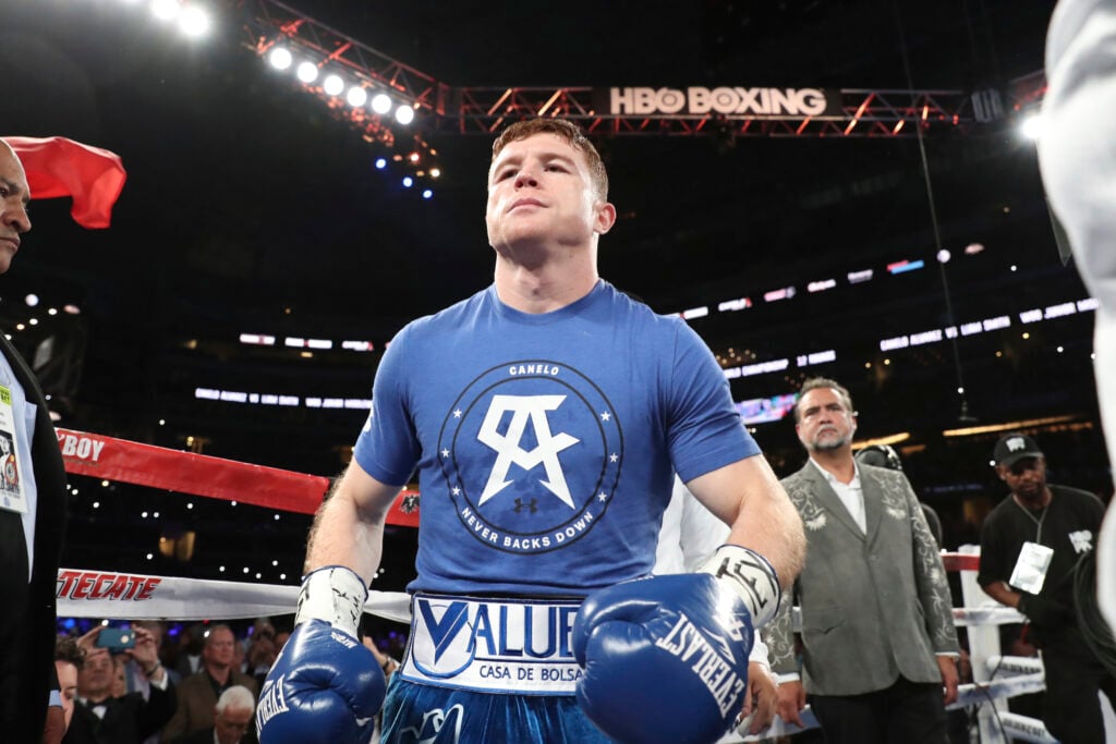 Canelo Alvarez looking up in ring ahead of boxing Liam Smith