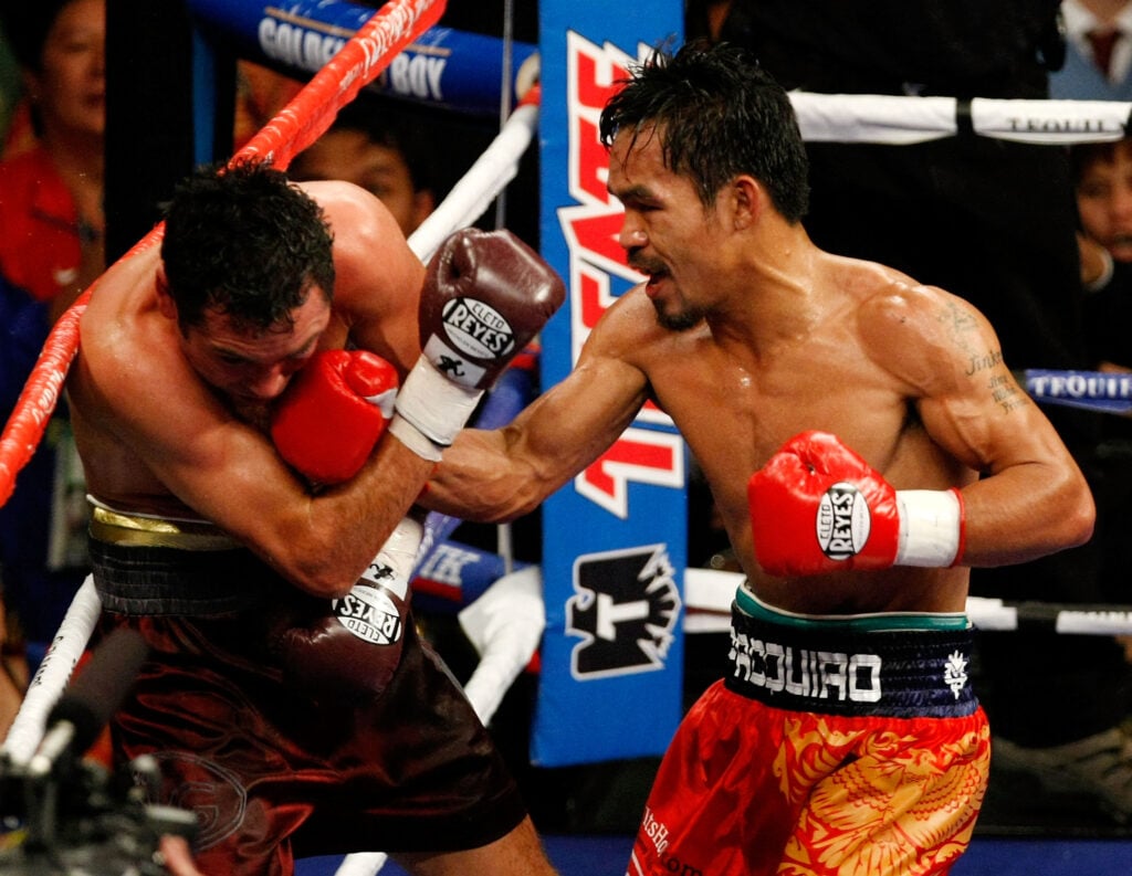 Manny Pacquiao had Oscar De La Hoya up against the ropes and lays in a right-handed body shot during their 2008 fight.