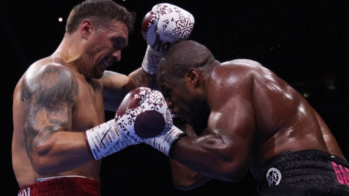 Daniel Dubois rushes in as Oleksandr Usyk raises his hands during their fight