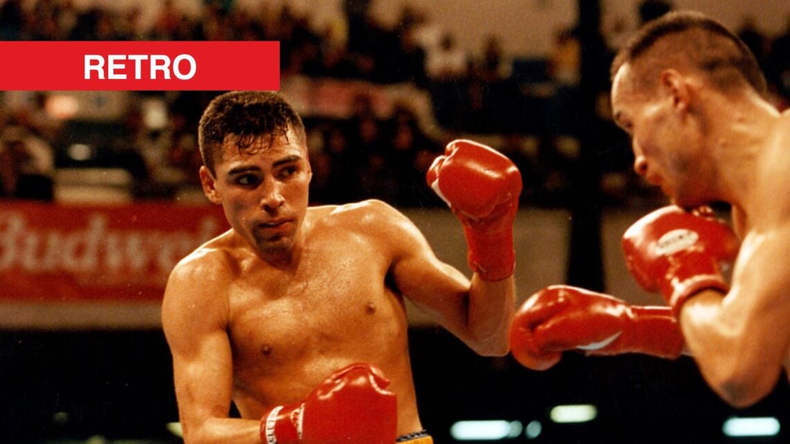 Oscar De La Hoya leaning back in ring versus opponent