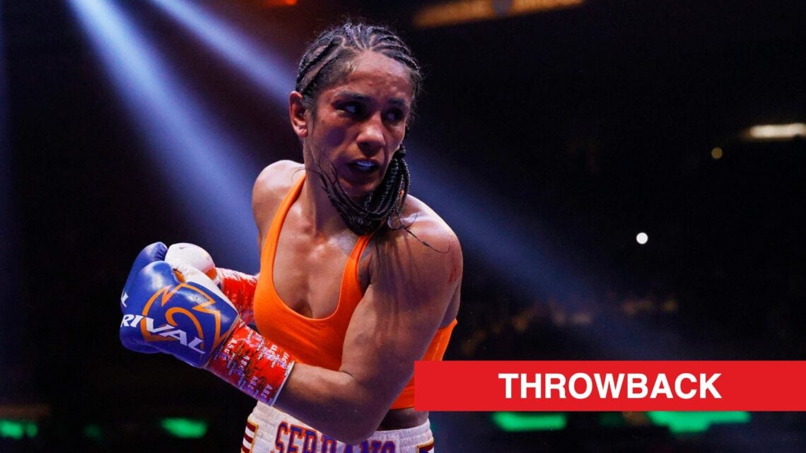 Amanda Serrano in an orange top and blue gloves during her first world title fight against Katie Taylor