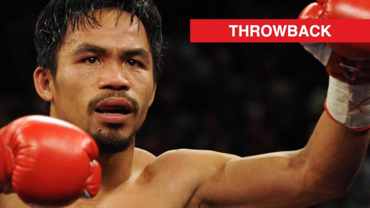 Manny Pacquiao raises an arm after victory in the ring