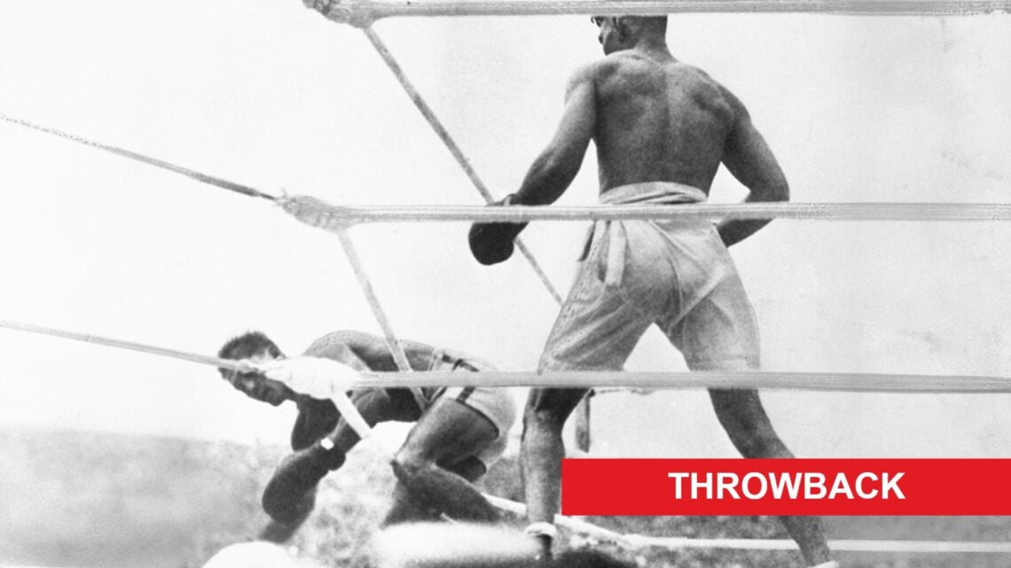 Jack Dempsey looks on at a downed Georges Carpentier during their heavyweight title fight