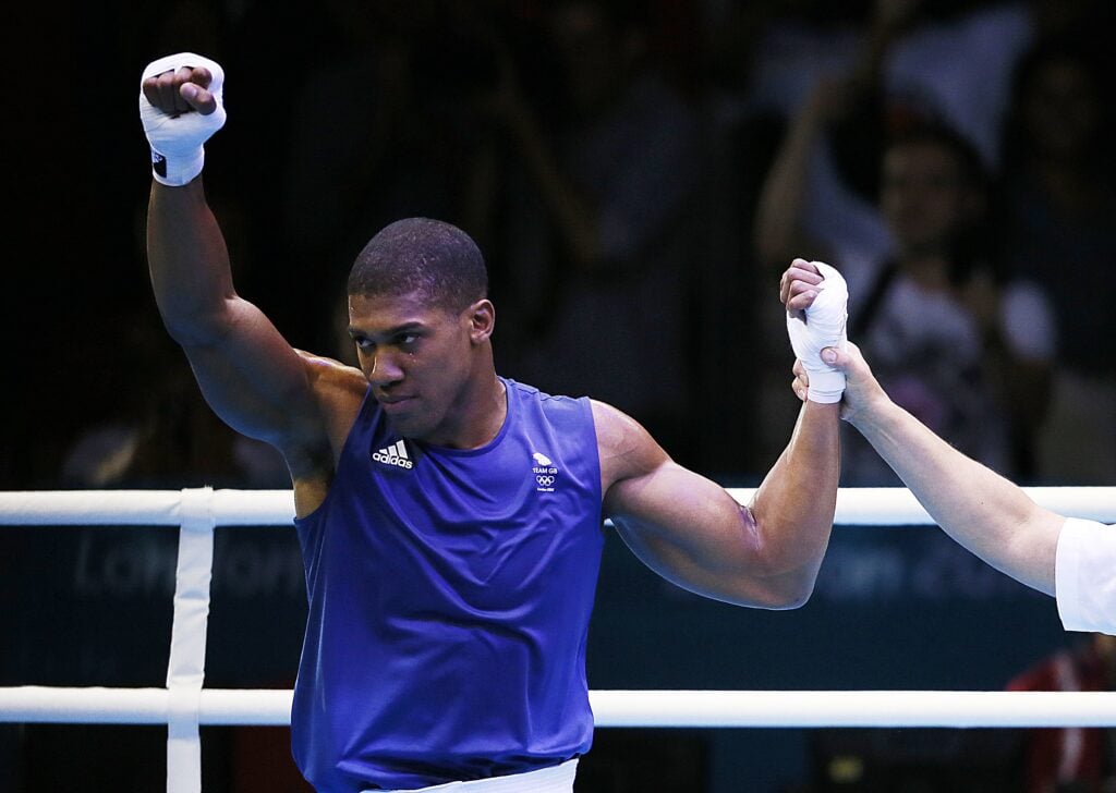 Anthony Joshua celebrates his round of 16 win over Savon Cotilla at the 2012 Summer Olympic Games