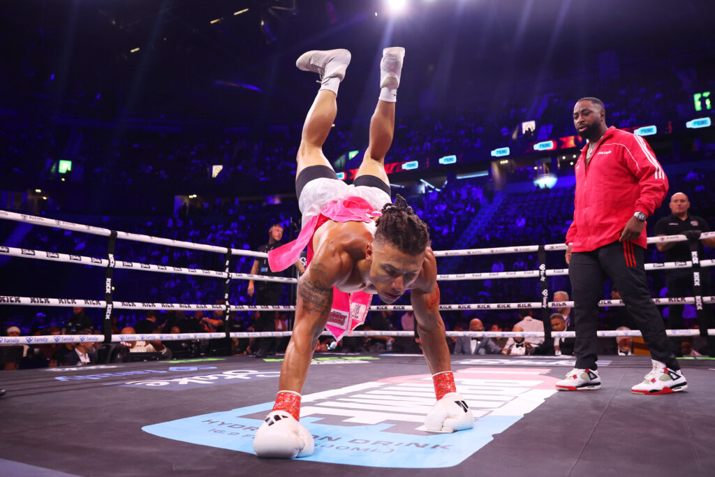 Chase DeMoor does a handstand after his fight with Tempo Arts