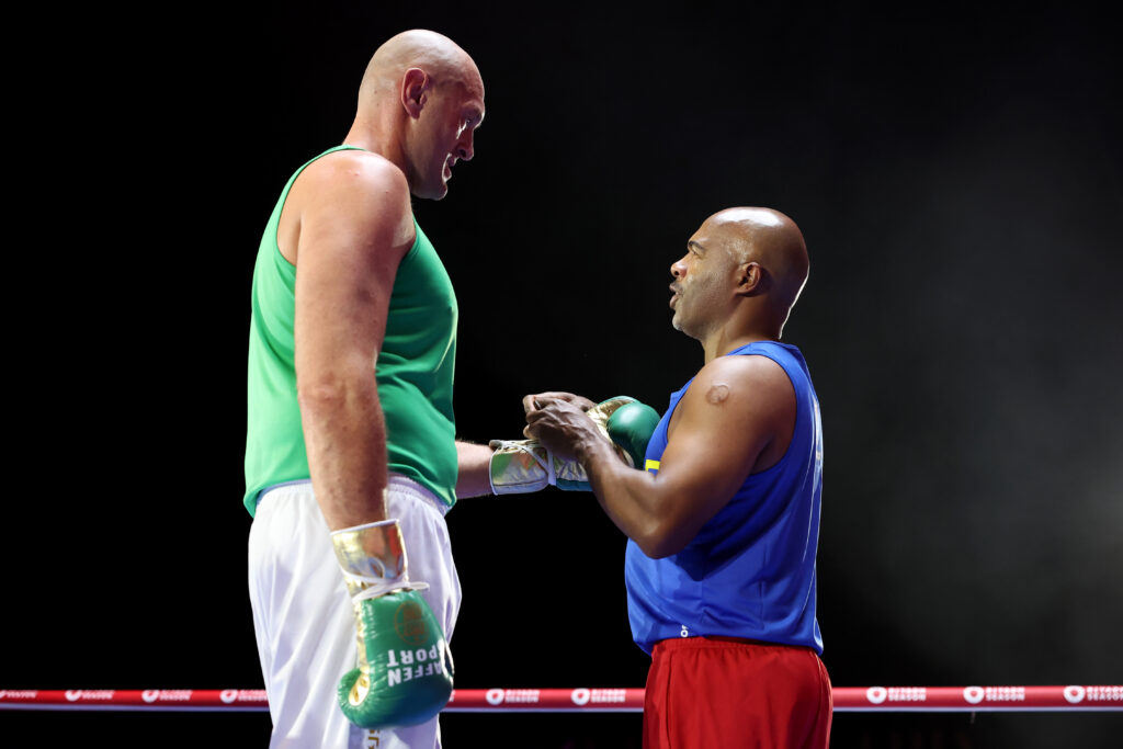 Sugar Hill Steward laces Tyson Fury's gloves at media workout