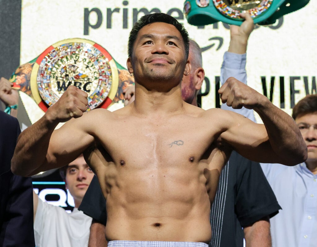 Manny Pacquiao poses on the scale during the ceremonial weigh-in for his fight against Mario Barrios