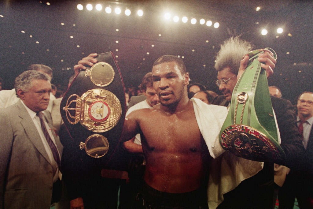 Mike Tyson celebrates defeating Tony Tucker