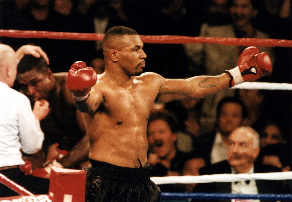 Mike Tyson celebrates in the ring after a knockout win