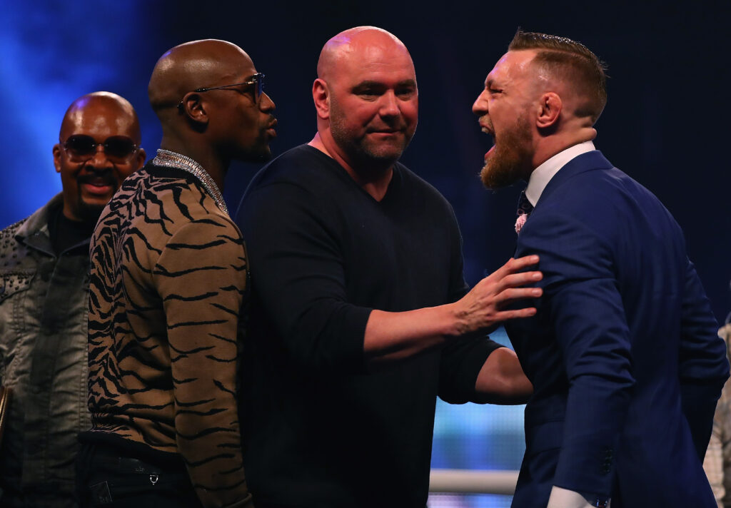 Conor McGregor held back by Dana White while yelling at Floyd Mayweather