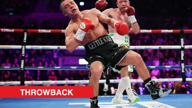 Image of Nick Ball stumbling in the ring with TJ Doheny looking towards him with throwback label