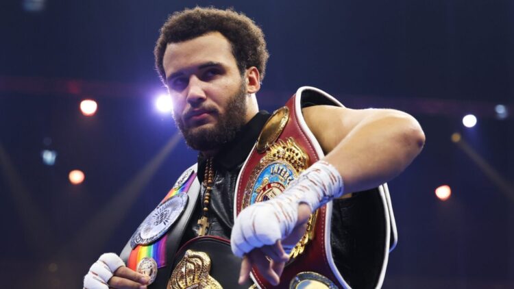 Close-up of Itauma with belts over his shoulders