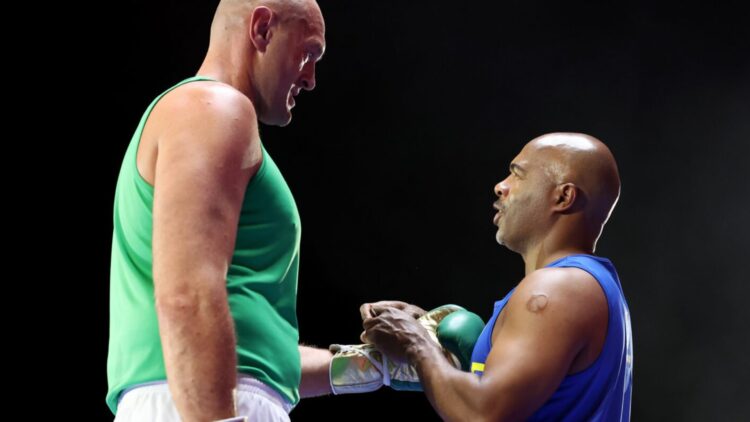 Close-up of Sugar Hill Steward lacing Tyson Fury's gloves at media workout