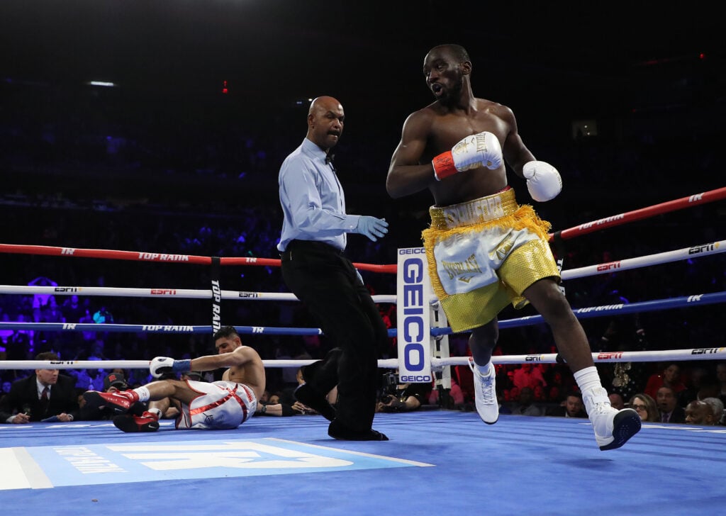 Terence Crawford runs to his corner after knocking down Amir Khan