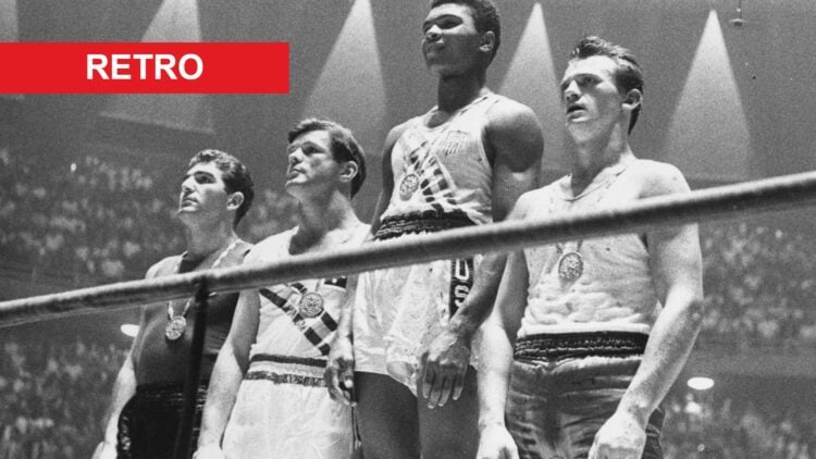 Muhammad Ali stands on the podium after winning a gold medal in 1960